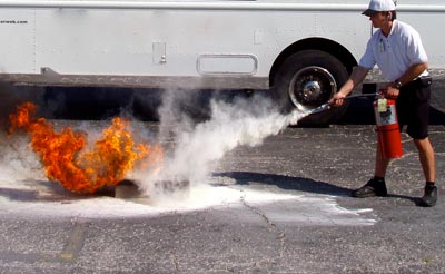 One of our service techs demonstrating the proper use of fire extinguisher.